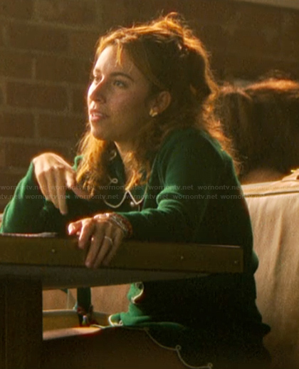 Amanda’s green scalloped cardigan and mini skirt on The Runarounds