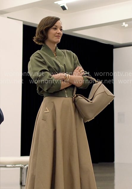 Celine’s green bomber jacket and beige skirt on The Morning Show