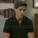 Smitty’s black polo shirt with blue trims on Beyond the Gates