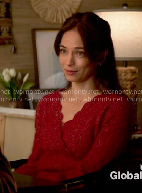 Cassandra’s red scalloped trim sweater on Murder in a Small Town
