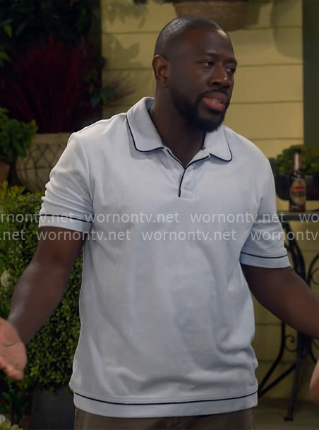 Malcolm’s light blue polo shirt on The Neighborhood