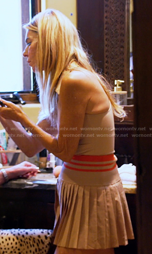 Nicolle’s pink beige sleeveless top and pleated skirt on The Golden Bachelor
