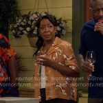 Tina’s orange floral shirt on The Neighborhood