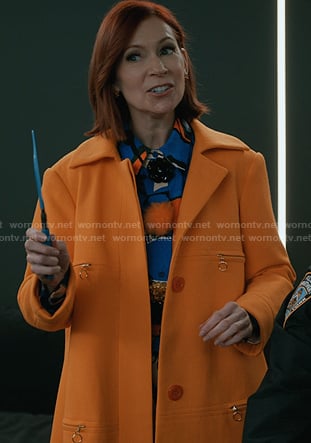 Elsbeth’s blue print blouse and orange coat on Elsbeth