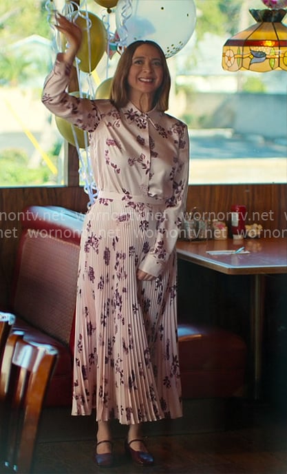 Molly’s pink floral shirt and pleated skirt on Loot