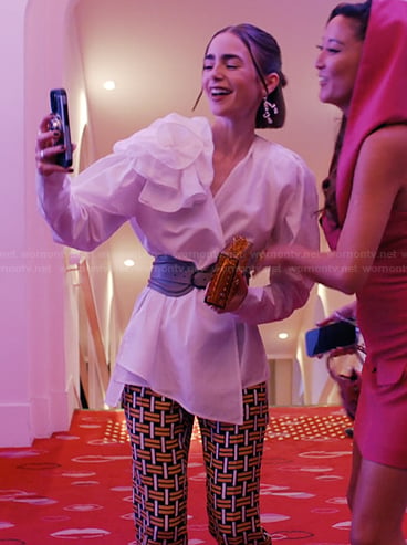 Emily’s printed pants and clutch bag on Emily in Paris