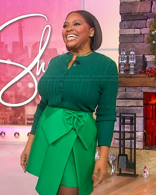 Sherri’s green cable knit sweater and skirt on Sherri