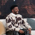 Trell Thomas’s white and brown animal print sweater on Access Hollywood