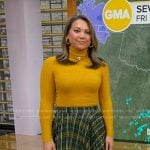 Ginger’s yellow turtleneck sweater and green plaid skirt on Good Morning America