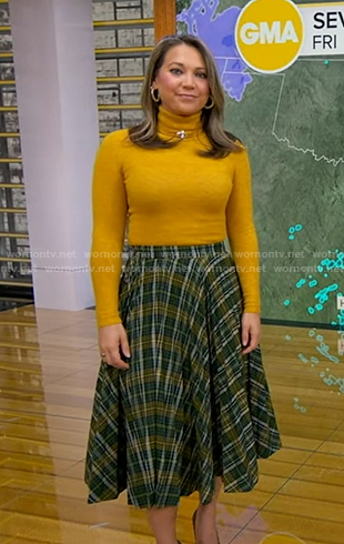 Ginger’s yellow turtleneck sweater and green plaid skirt on Good Morning America