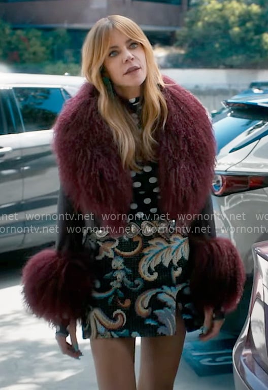 Morgan’s polka dot mesh top, printed skirt and red fur collar jacket on High Potential