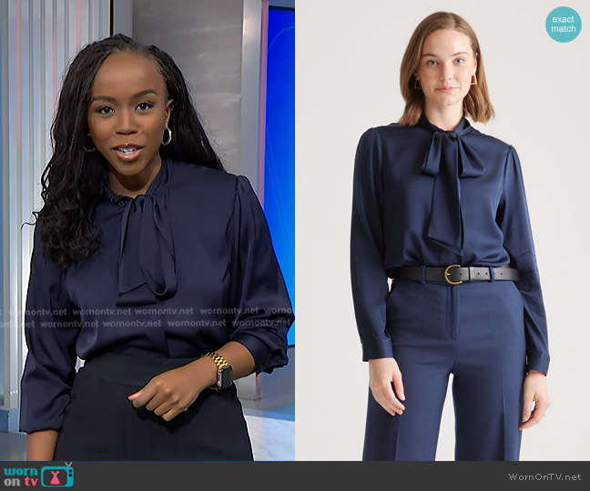 Quince Washable Stretch Silk Tie Neck Blouse in Navy worn by Zinhle Essamuah on NBC News Daily