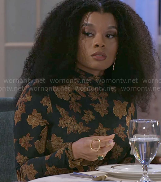Eva’s black floral print top on Beyond the Gates