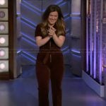 Kelly’s brown zip front jumpsuit on The Kelly Clarkson Show