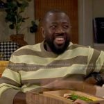 Malcolm’s green and brown striped sweater on The Neighborhood