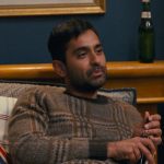 Naveen’s brown plaid sweater on The Burbs