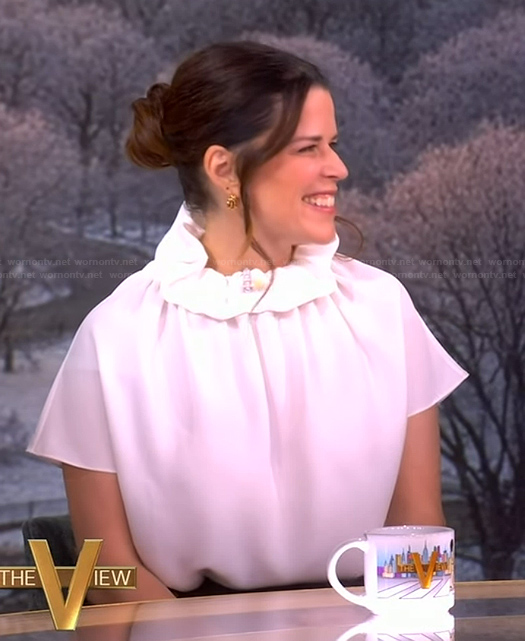 Neve Campbell’s white ruffle neck top on The View
