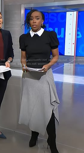 Zinhle’s black collared sweater and grey asymmetric skirt on NBC News Daily