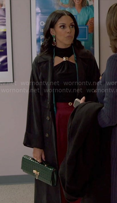 Dani’s black halter top with metal detail and green satin jacket on Beyond the Gates