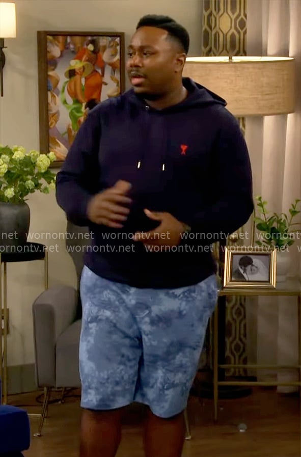 Marty’s navy hoodie and blue printed shorts on The Neighborhood