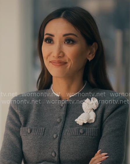Ali’s grey cardigan with flower applique on Running Point