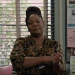 Dia’s black pleated wrap dress on Abbott Elementary