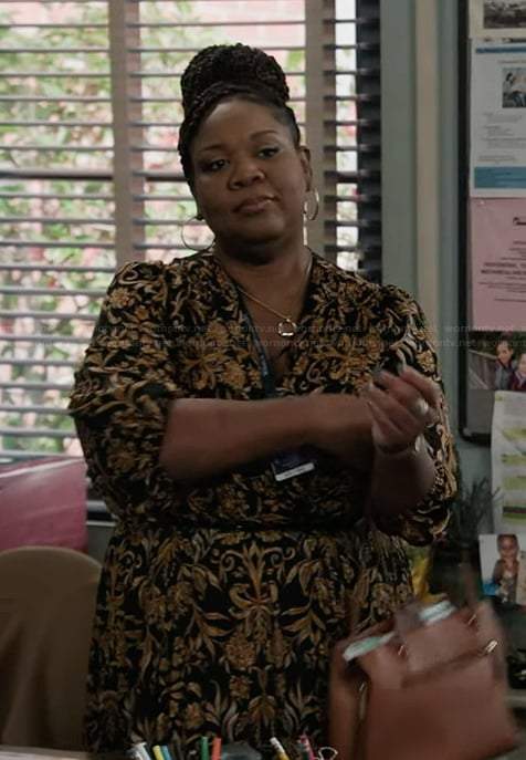 Dia’s black pleated wrap dress on Abbott Elementary