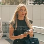 Isla’s black draped dress with metal details on Running Point