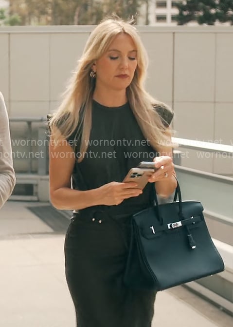 Isla’s black draped dress with metal details on Running Point