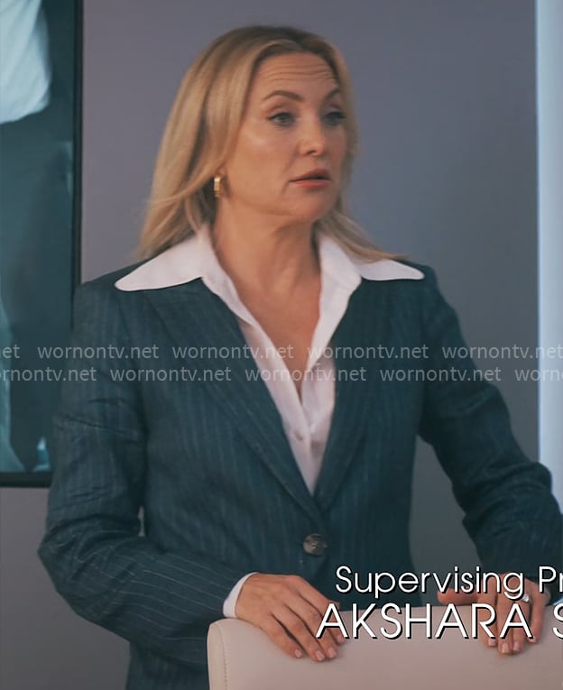 Isla’s navy pinstripe suit on Running Point