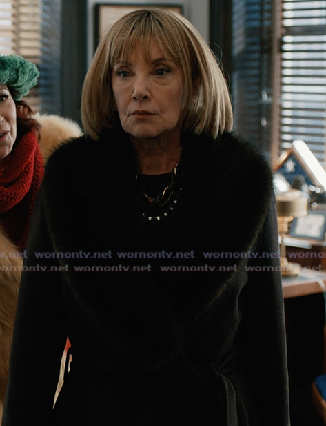 Izzy’s black shearling collar coat on Elsbeth