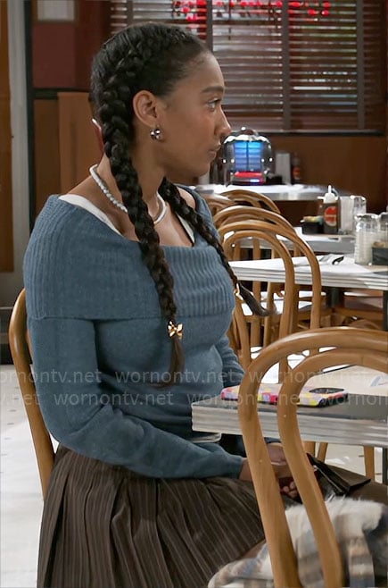 Samantha’s blue off-shoulder sweater and brown pleated skirt with duck bag on Beyond the Gates