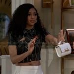 Kat’s striped crop top with tie neck and white pleated skirt on Beyond the Gates