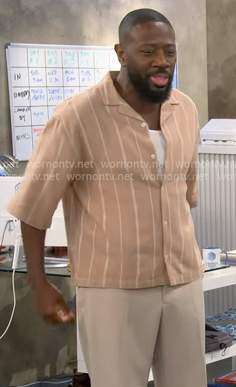 Malcolm’s beige striped shirt on The Neighborhood