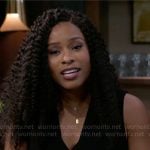Naomi’s black top with gold buttons on Beyond the Gates