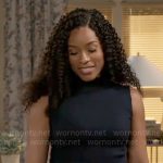 Naomi’s navy shoulder detail top and pinstripe pants on Beyond the Gates
