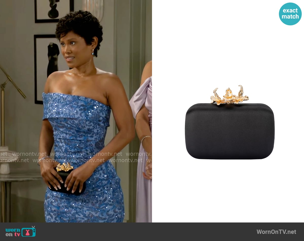 Olga Berg Adele Orchid Lock Clutch worn by June Hughes (Jasmine Burke) on Beyond the Gates