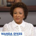 Wanda Sykes's white eyelet short sleeve top on Good Morning America