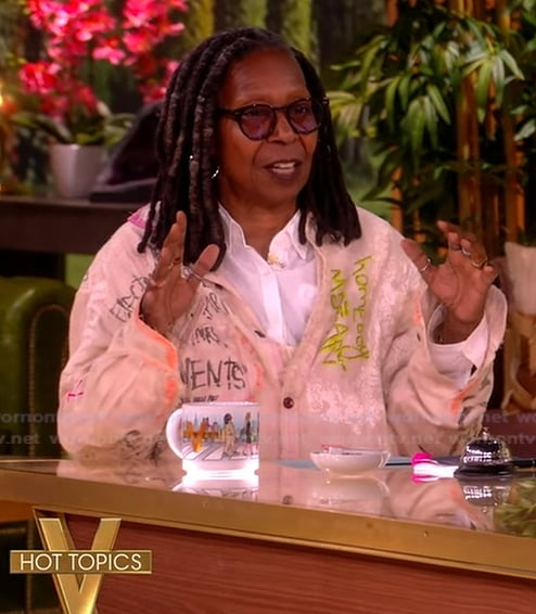 Whoopi’s embroidered denim overalls and printed shirt on The View
