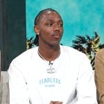 Hercy Miller’s white logo print long sleeve tee on Access Hollywood