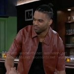 Izaiah's red leather zip shirt and camo pants on Beyond the Gates