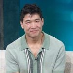 Joel Kim Booster's green stripe shirt on Access Hollywood