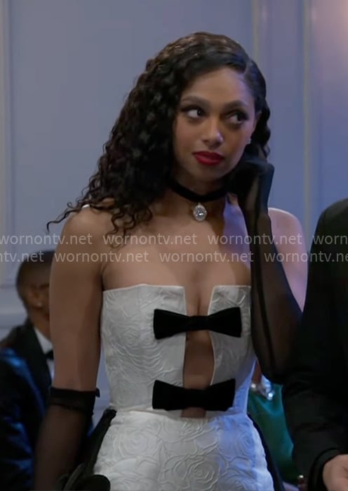 Kat’s white dress with black bows on Beyond the Gates