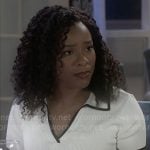 Naomi's white polo top with contrast trims on Beyond the Gates