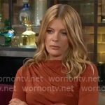 Phyllis's rust brown draped top and metallic clutch on The Young and the Restless