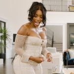 Porsha’s white marble print off shoulder jumpsuit on The Real Housewives of Atlanta