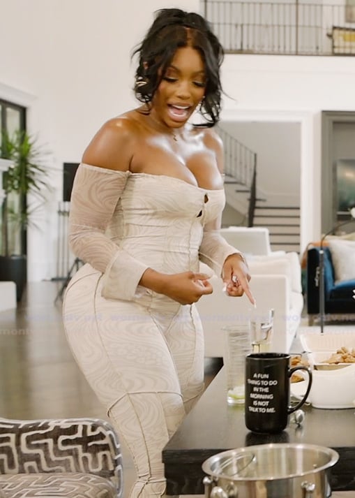 Porsha’s white marble print off shoulder jumpsuit on The Real Housewives of Atlanta