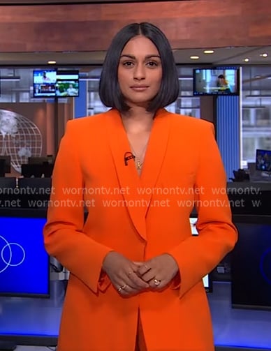 Shanelle Kaul’s orange shawl collar blazer on CBS Evening News