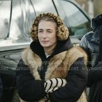 Amanda’s beige fur vest and leopard earmuffs on In The City