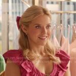 Elle's pink ruffled dress with heart buttons on Elle